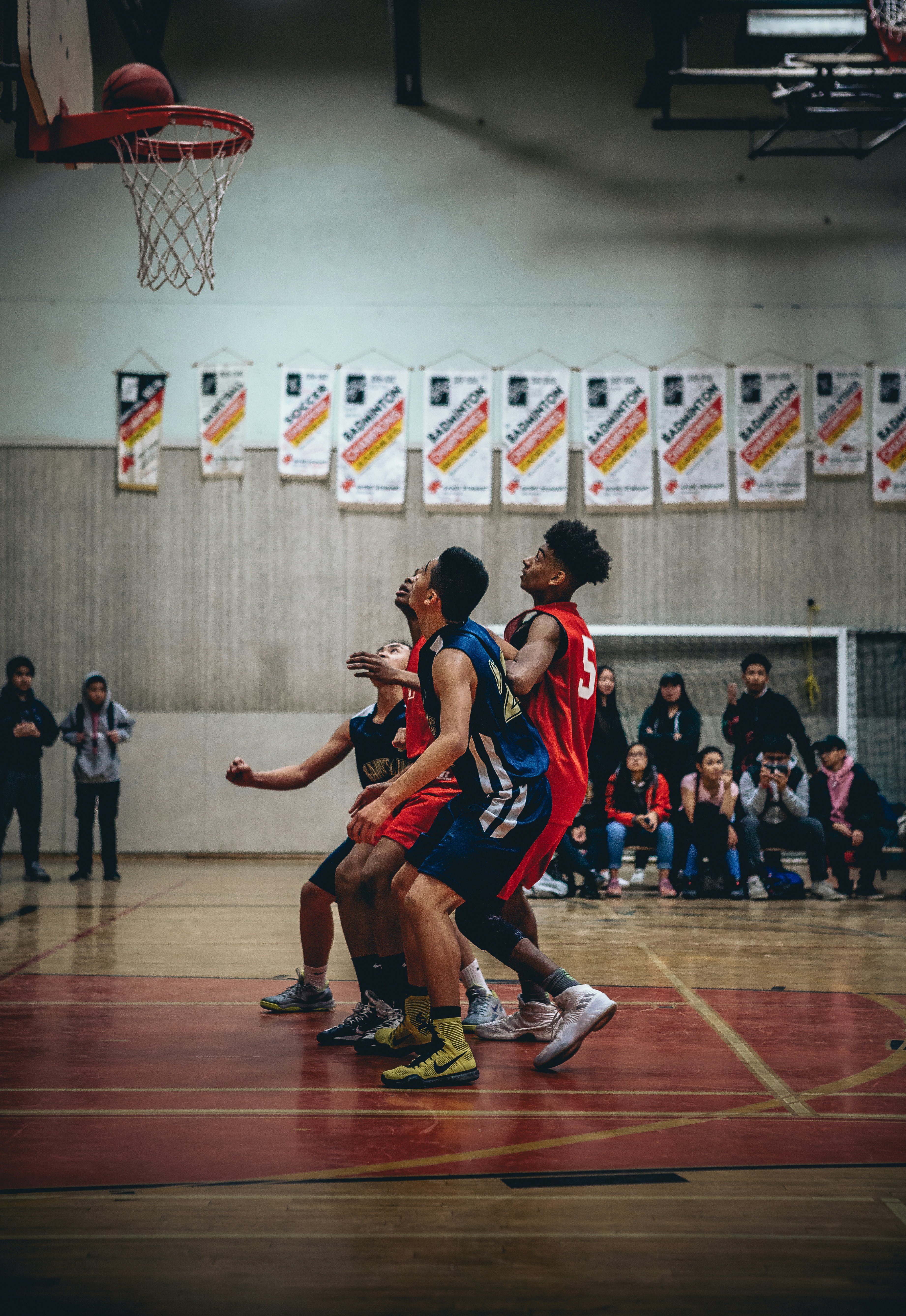 Youth basketball players battling under the basket